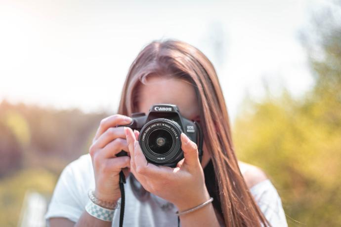 women holding a camera close-up photography